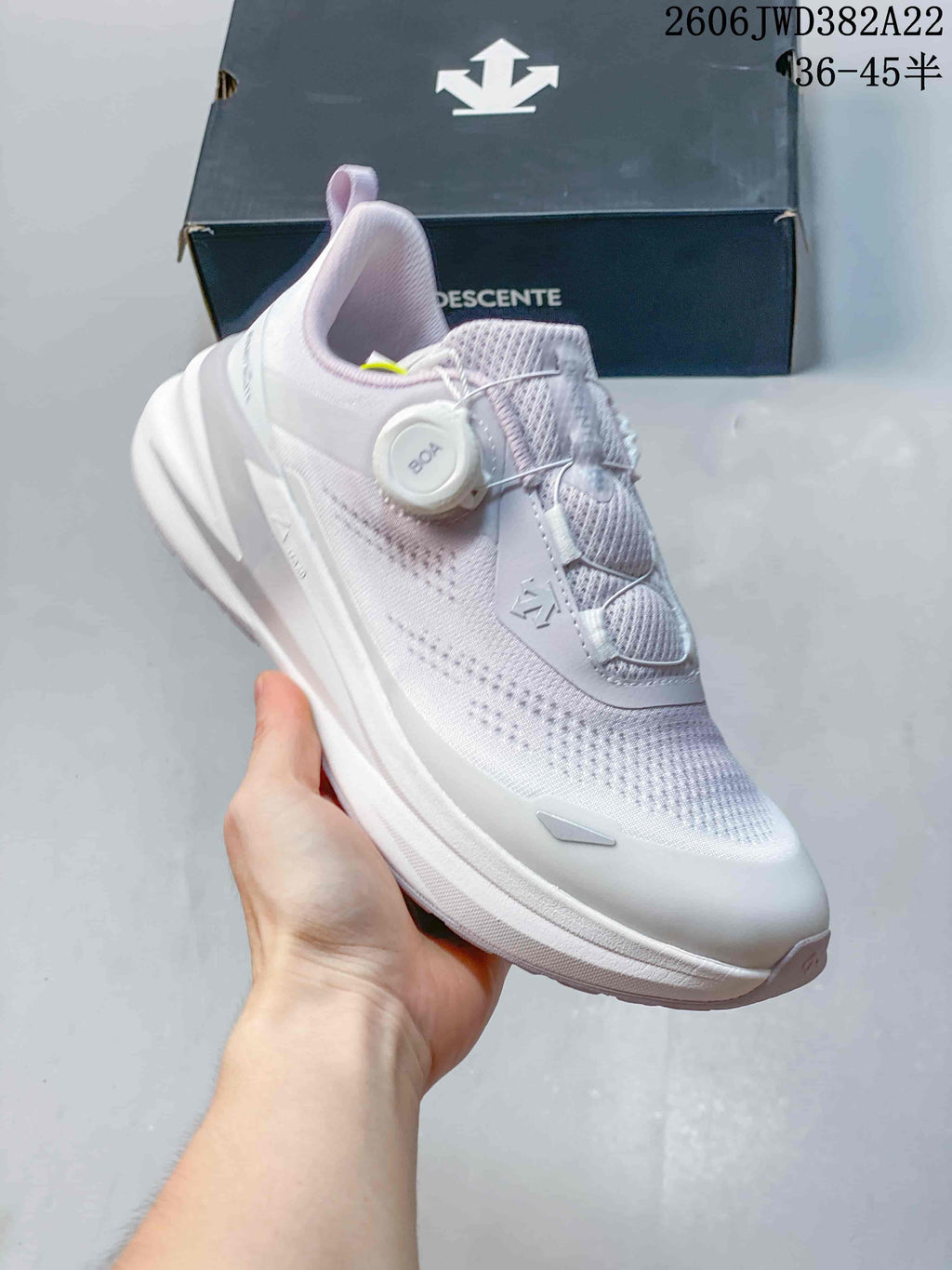 Angled view of the DESCENTE running sneaker with its BOA dial and knit upper