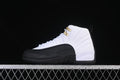 Side view of a white and black Jordan Air Jordan 12 high-top sneaker with gold-tone lace hardware.