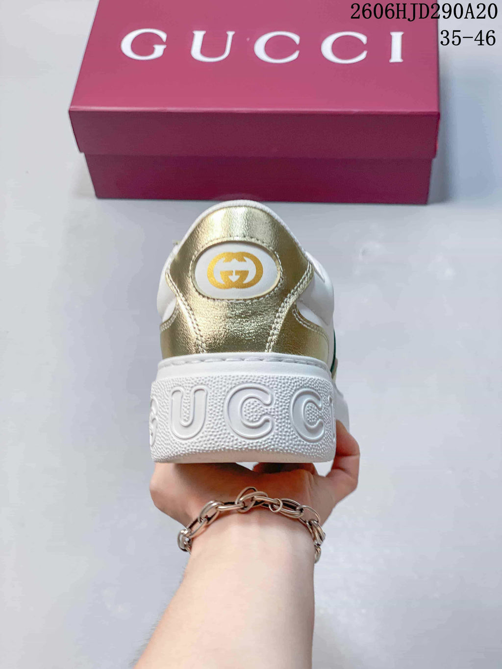 Rear view of the sneaker with a gold-tone heel panel and raised lettering on the sole