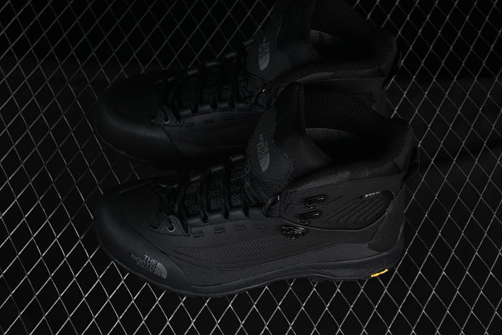 Pair of black mid-height boots shown from above at an angle.