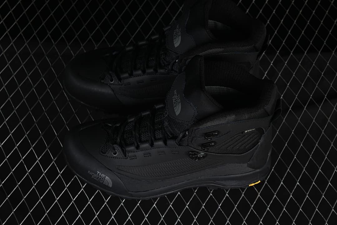 Pair of black mid-height boots shown from above at an angle.
