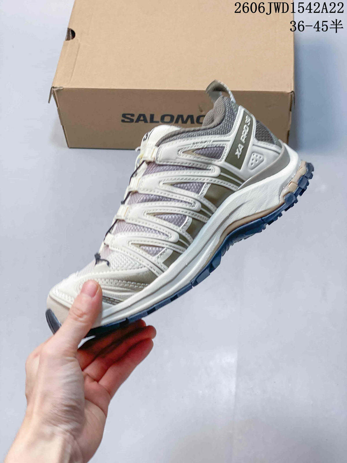 Side view of a cream and gray Salomon XA Pro 3D sneaker
