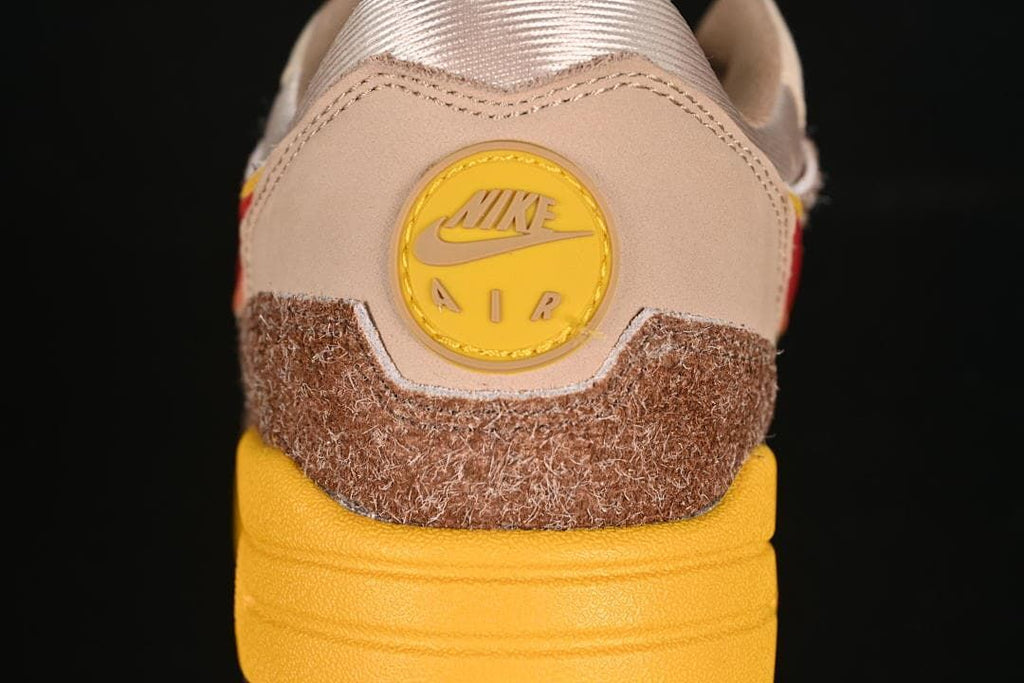 Rear view showing the yellow Nike Air heel badge and layered brown upper.