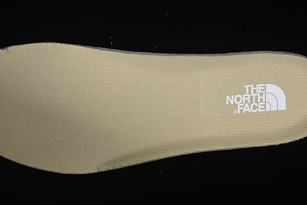 Close-up of the tan textured insole with The North Face logo.
