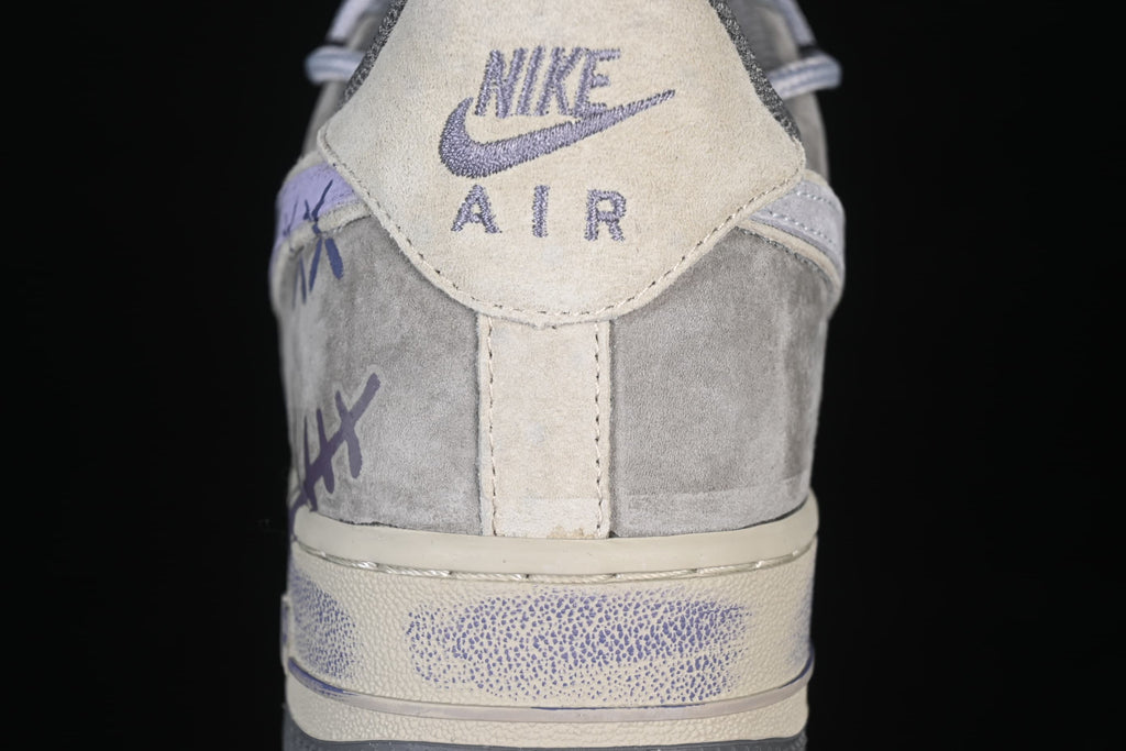 Close-up of the sneaker heel tab with Nike Air branding and hand-drawn markings