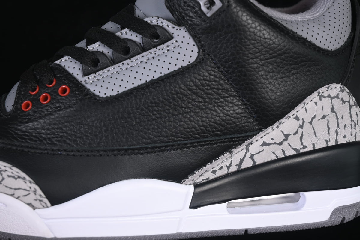 Close-up of the black side panel, grey cement-pattern overlay and midsole window