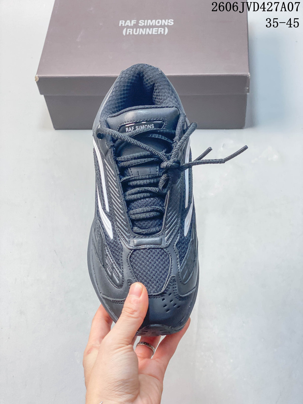 Top view of a charcoal Raf Simons lace-up sneaker with a rounded toe
