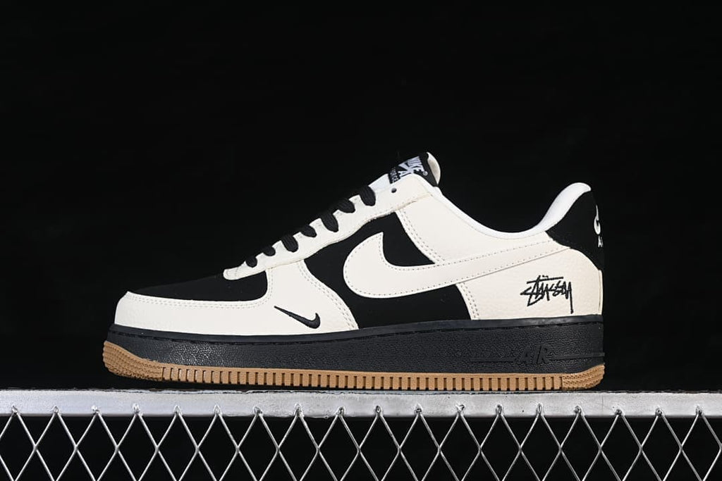 Side profile of the black and sail low-top sneaker with signature-style graphics