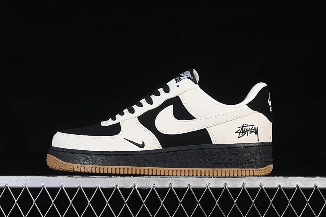 Side profile of the black and sail low-top sneaker with signature-style graphics