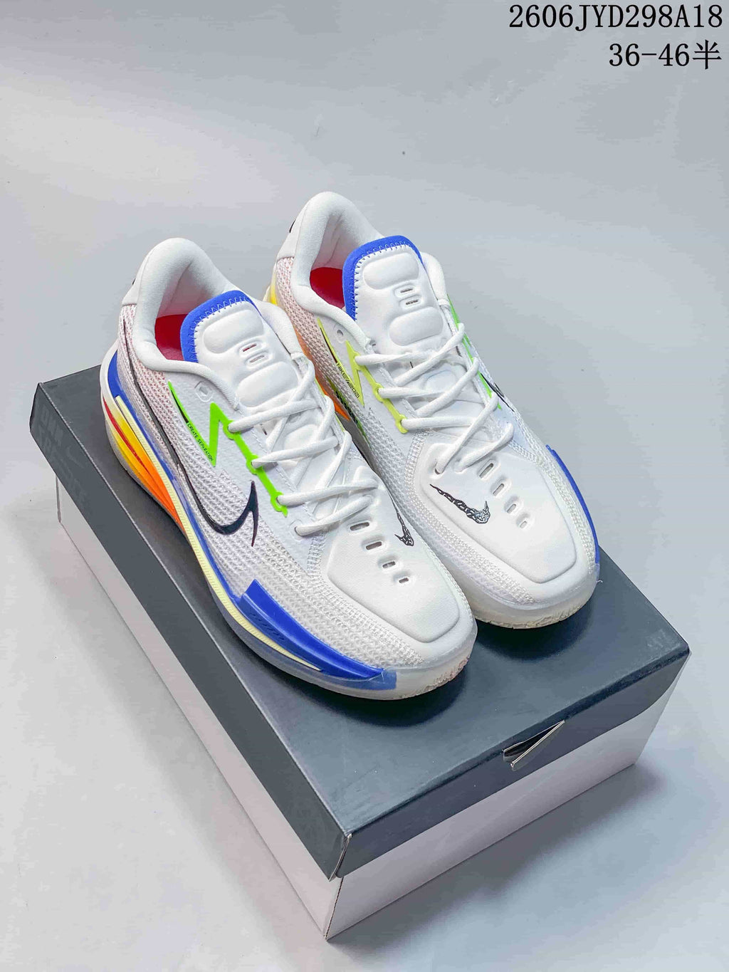 Pair of white Nike Air Zoom GT Cut low-top basketball shoes with colorful accents, displayed on a box.