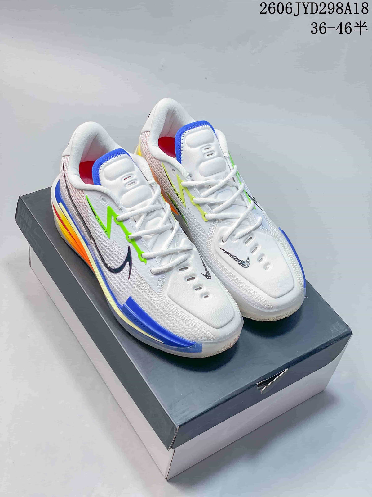 Pair of white Nike Air Zoom GT Cut low-top basketball shoes with colorful accents, displayed on a box.