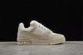 Side profile of a beige and white Louis Vuitton Archlight sneaker against a black background.