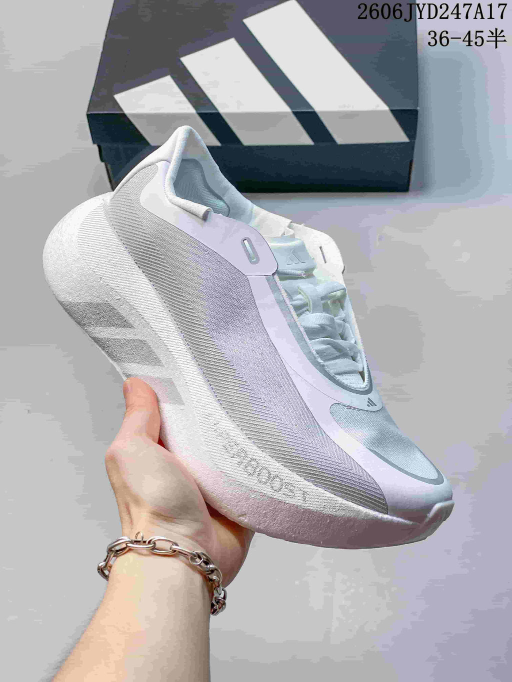 Dark gray Adidas HYPERBOOST EDGE M shoe with a contrasting striped sole.