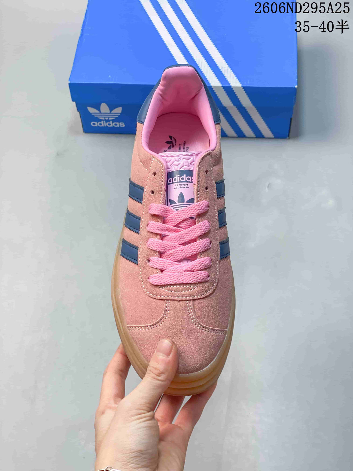 Top view showing pink laces, a rounded toe and navy stripes