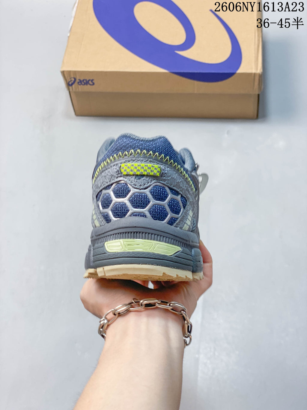 Rear view of a grey ASICS Gel-Kahana 8 FL sneaker showing its layered heel design