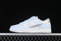 Side profile of a light blue, white, and silver low-top Nike Dunk sneaker