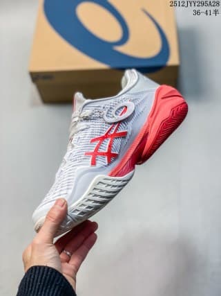 Side view of a white ASICS SKY ELITE FF 3 sneaker with red and blue detailing, held in front of an ASICS shoebox.