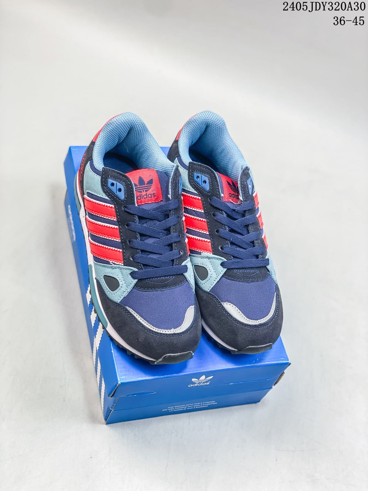Pair of Adidas Originals ZX 750 sneakers in navy, light blue, and red, shown from the front.