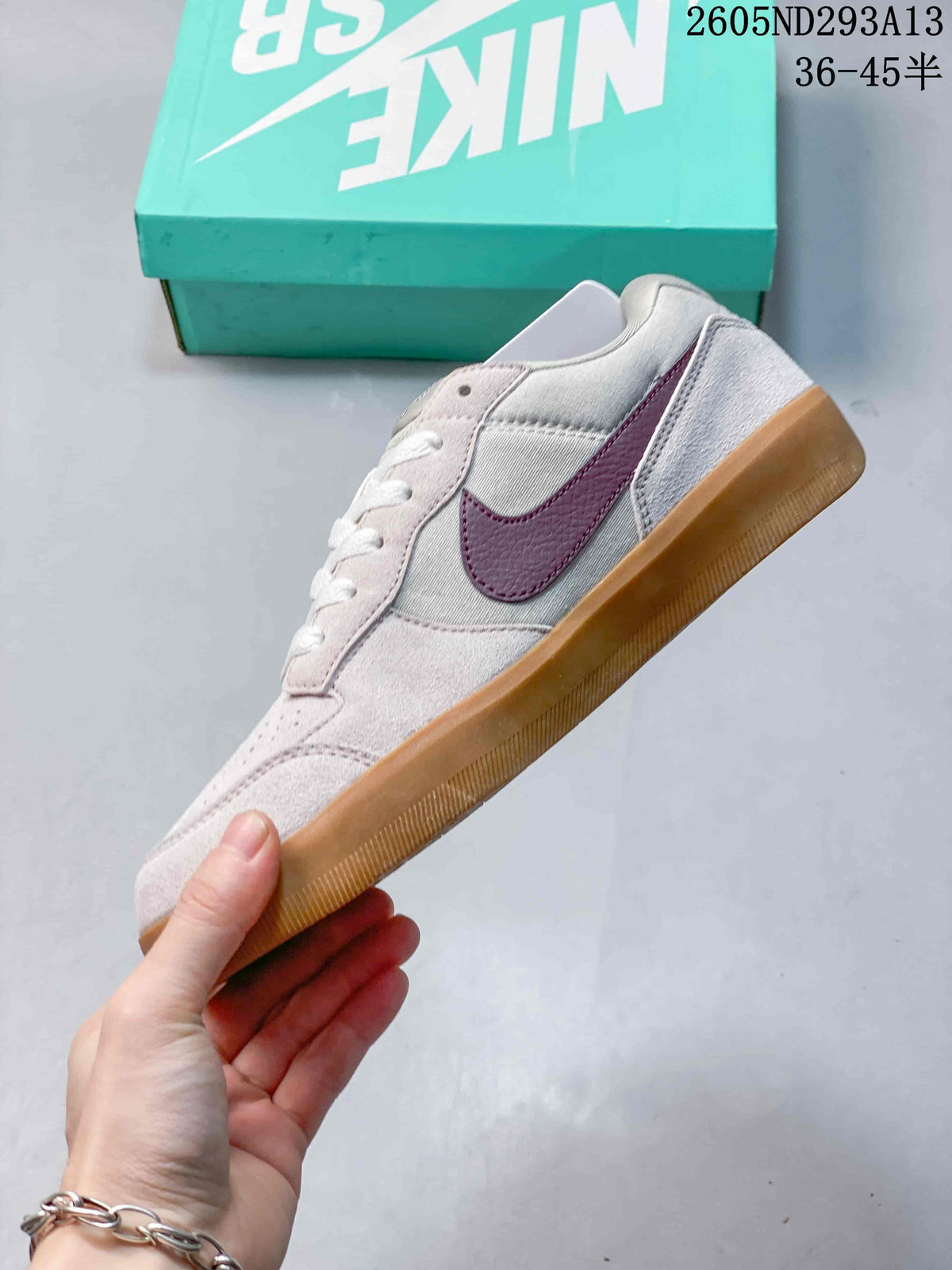 Side view of a pale pink and grey Nike SB Force 58 with burgundy Swoosh and gum-colored sole