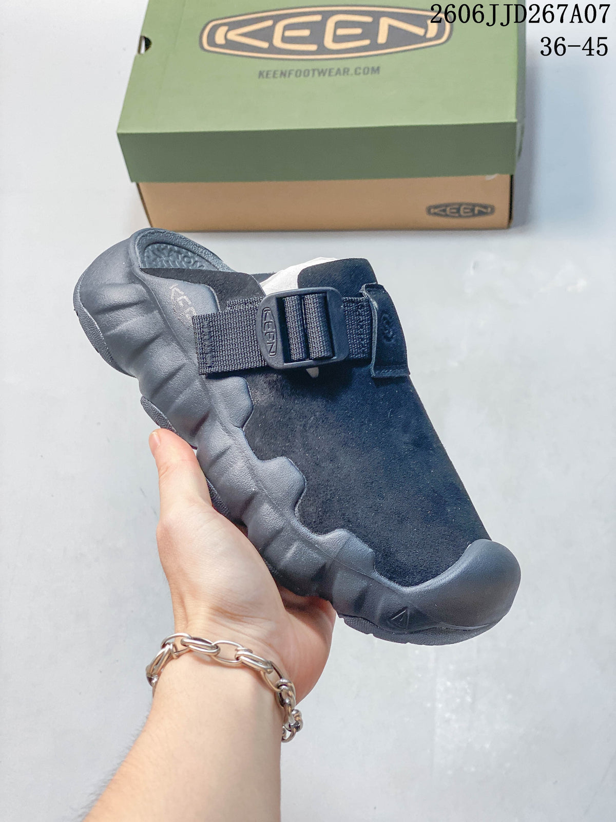 Angled view of the navy clog sandal with its strap and sculpted sole.