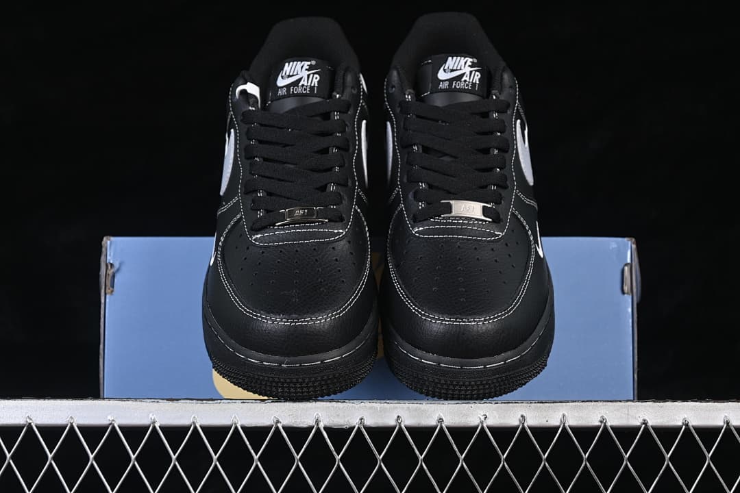 Front view of a pair of black and white low-top sneakers