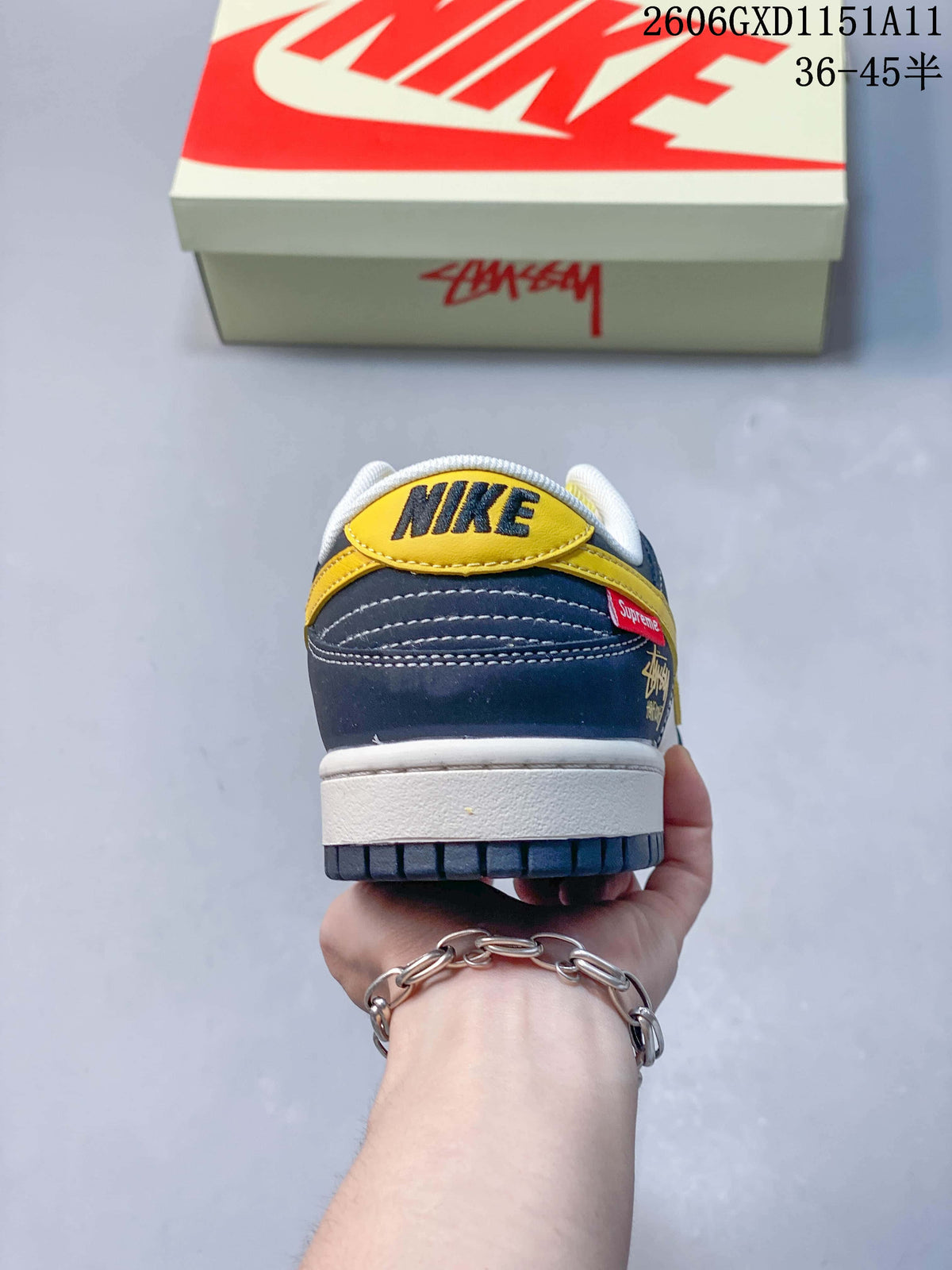 Rear view showing navy heel panels and yellow heel tab