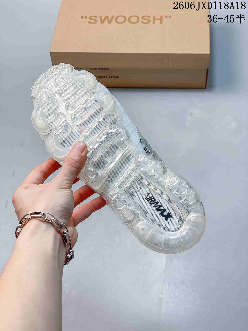 Underside view of the clear segmented air-cushion sole on a white sneaker