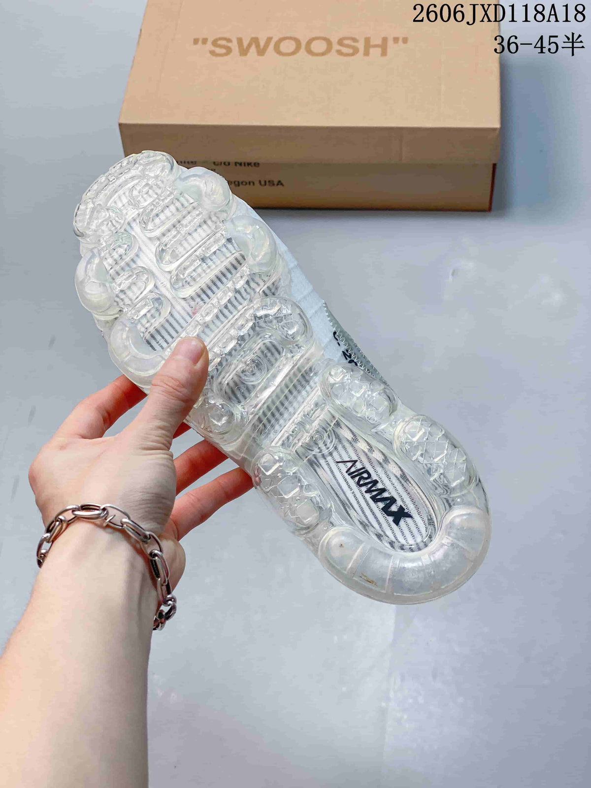 Underside view of the clear segmented air-cushion sole on a white sneaker