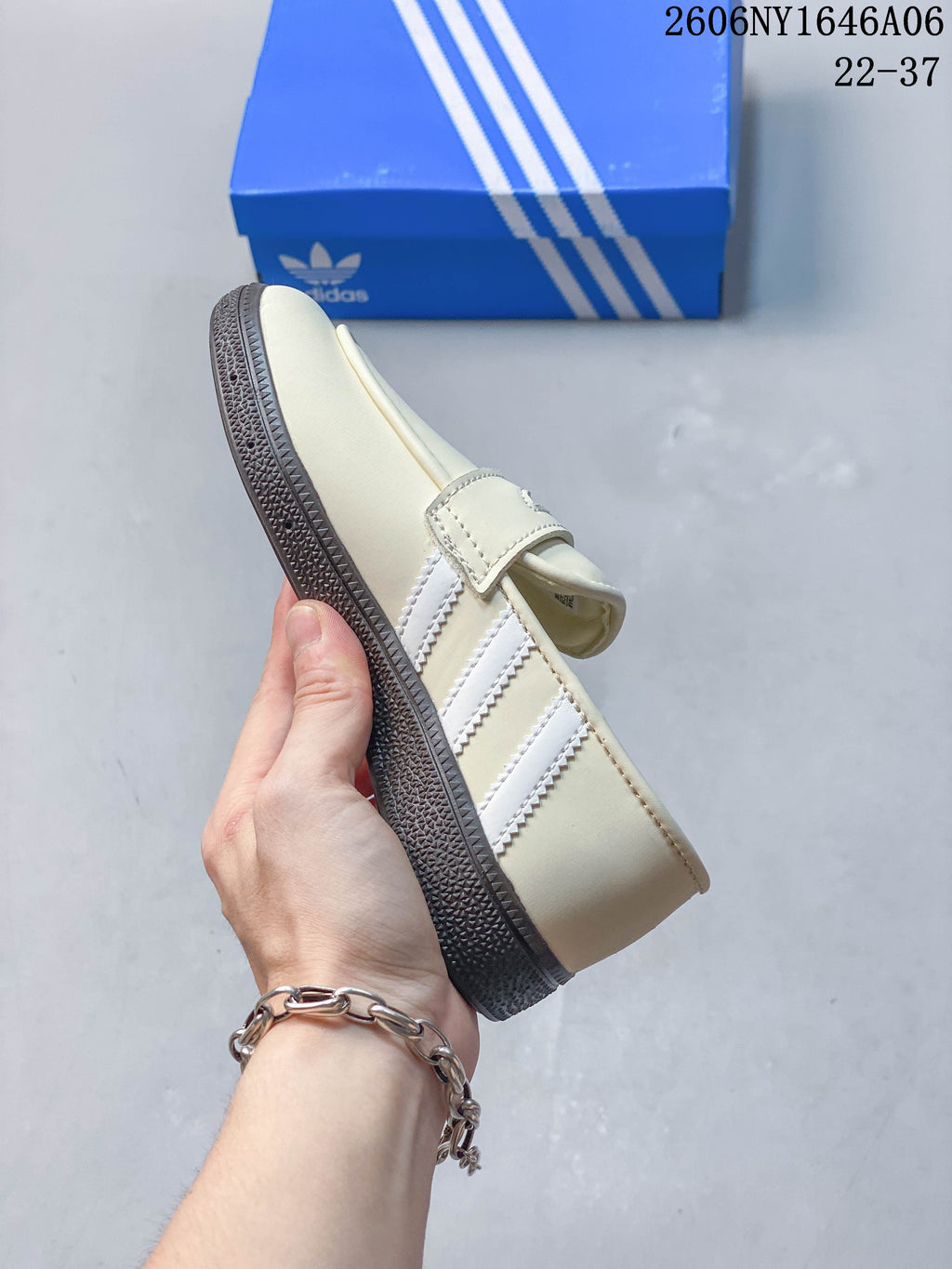 Side view showing three white stripes and a dark gum-look sole