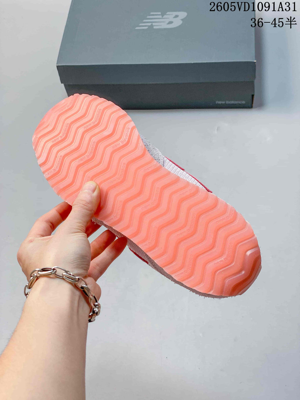 Close-up of the pink patterned outsole on a New Balance 471 sneaker.
