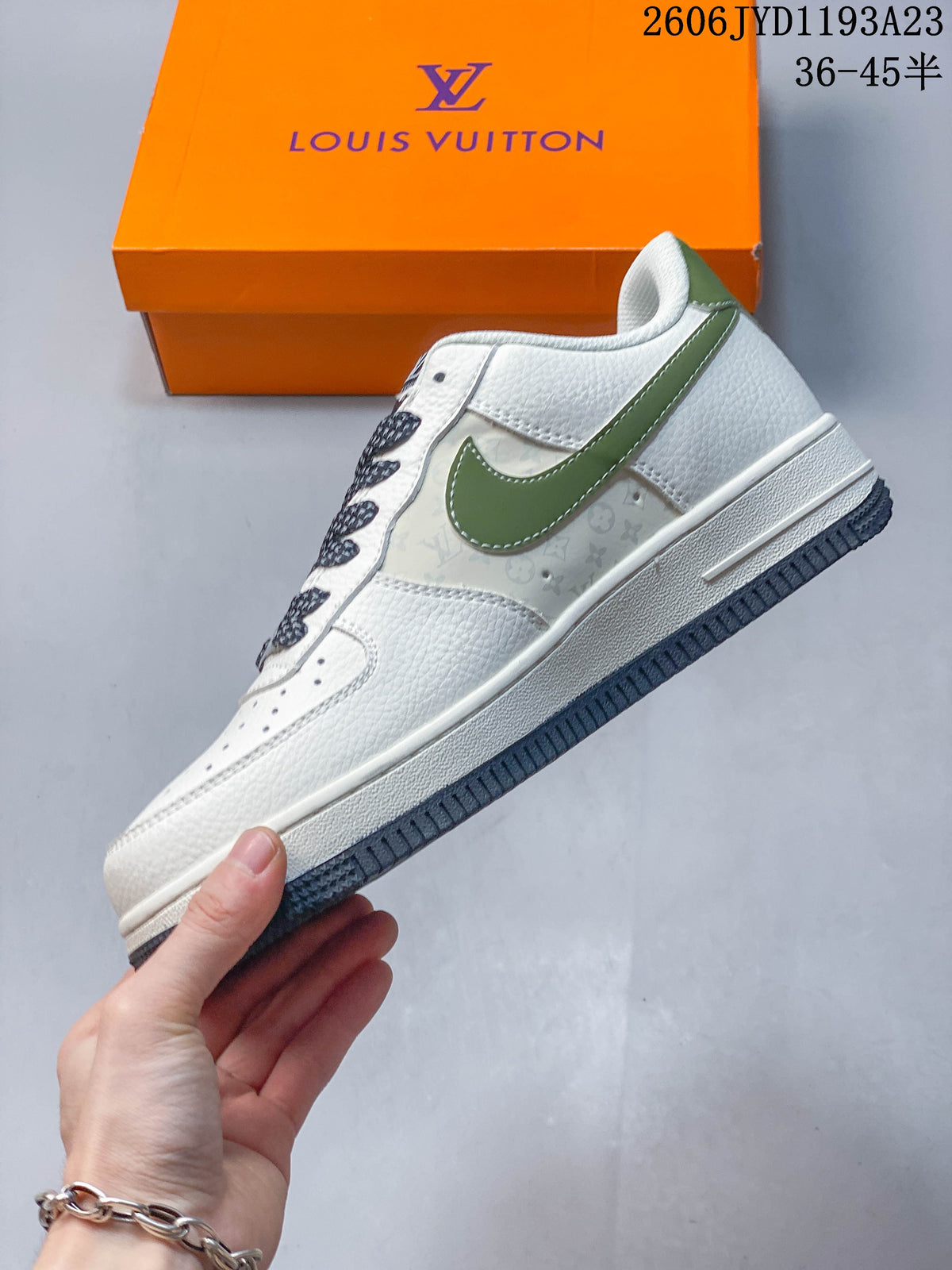 Side profile of a white low-top sneaker with green accents and a pale patterned side panel.