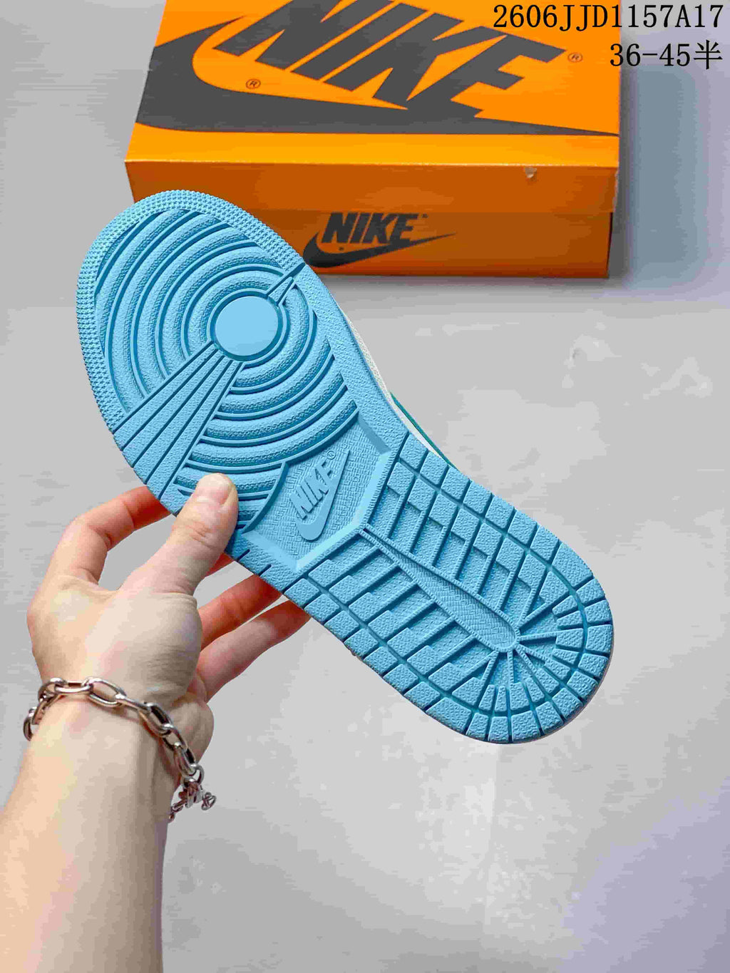 Close-up of the blue patterned outsole on the low-top sneaker.