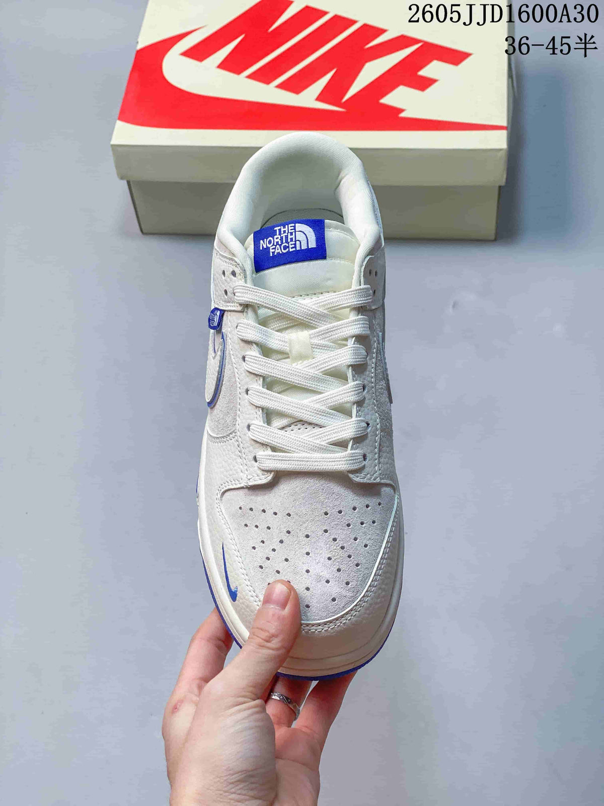 Top view showing the perforated toe, white laces, and blue tongue label
