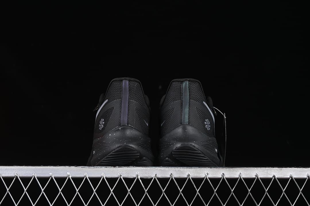 Rear view of the pair showing heel details and speckled midsoles.