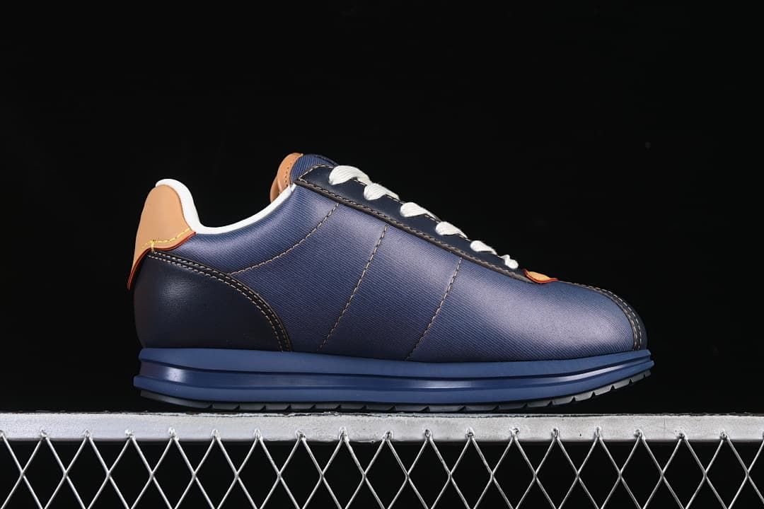Side profile of the dark blue low-top sneaker