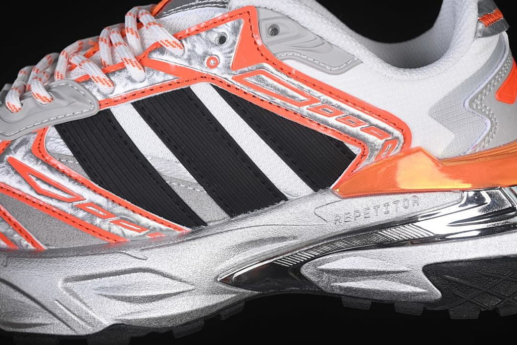 Close-up of the side stripes, orange overlays, and sculpted midsole