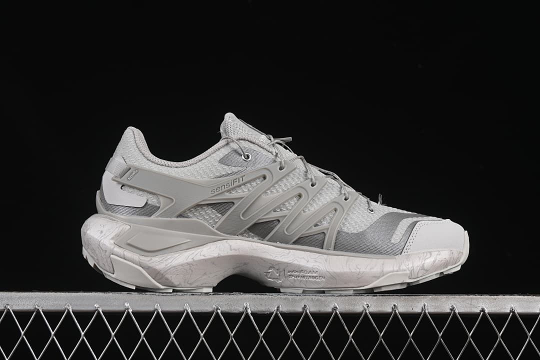 Side view showing the sculpted structure and light patterned midsole