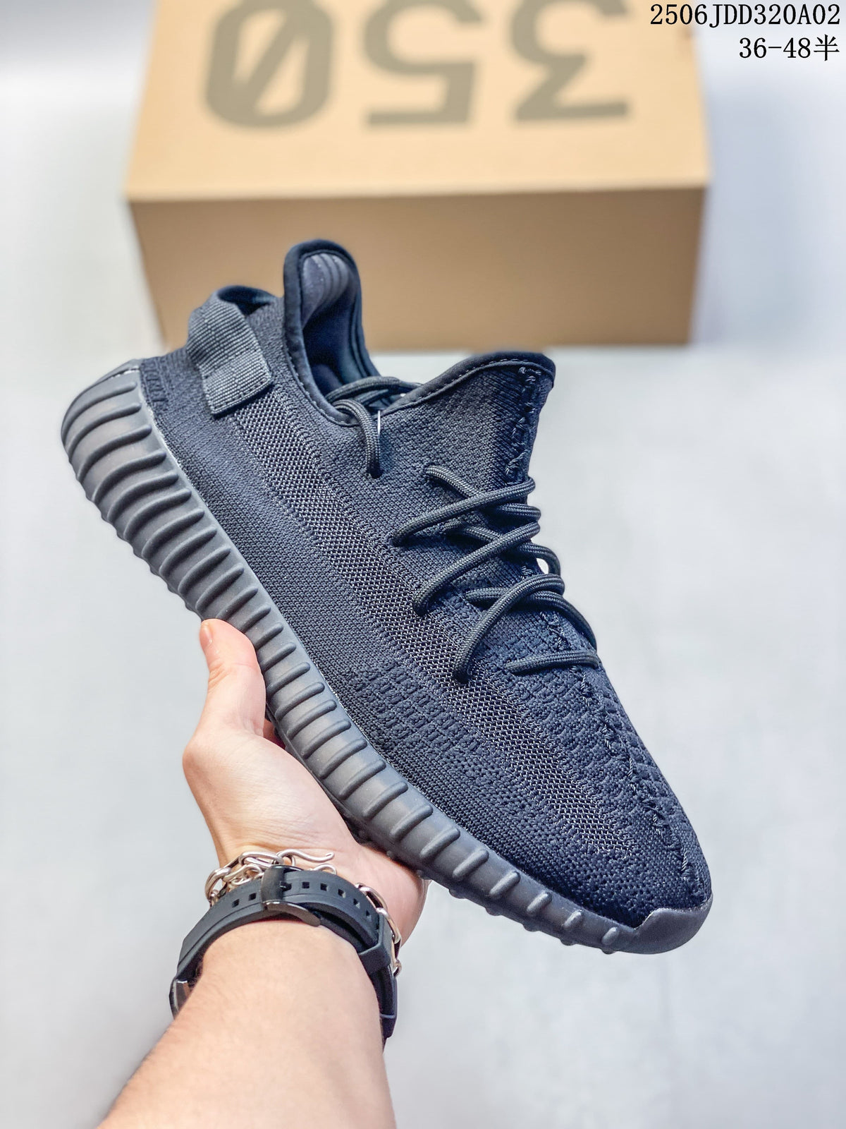Dark monochrome Adidas Yeezy-style sneaker with a ribbed sole