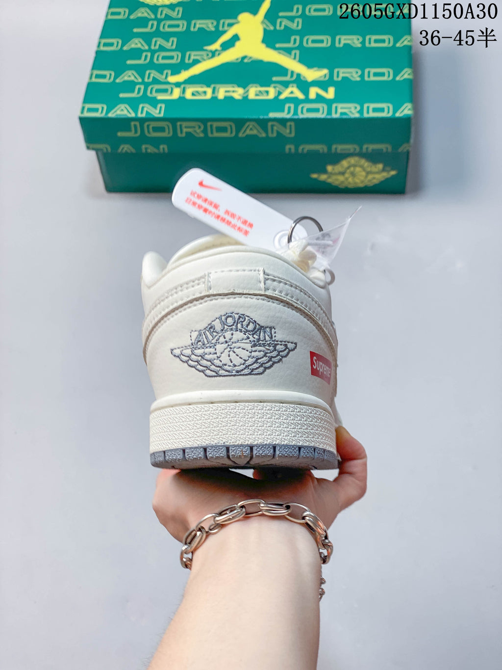 Rear view showing a winged shoe logo and a small red heel label.