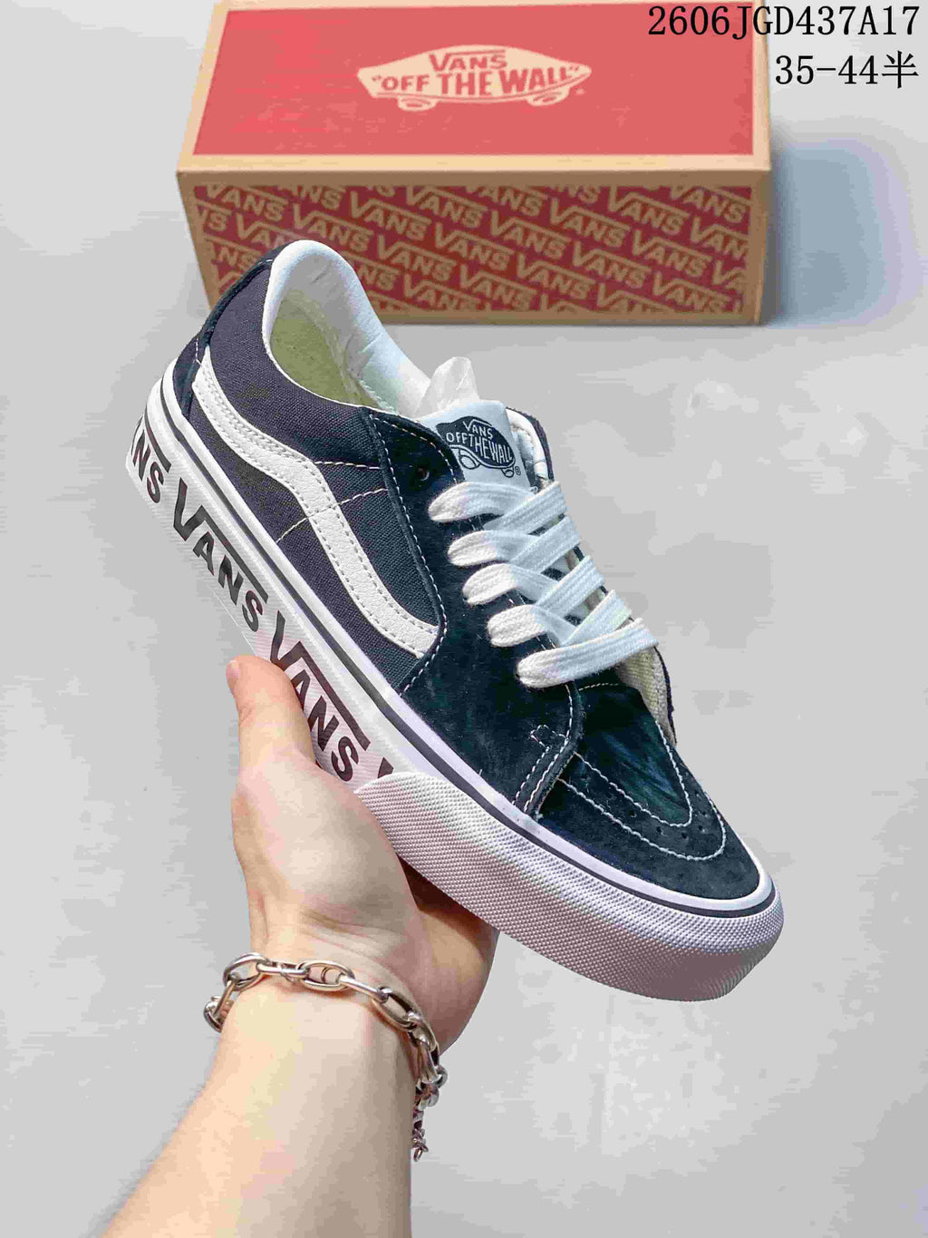 Angled view of the navy and white low-top sneaker