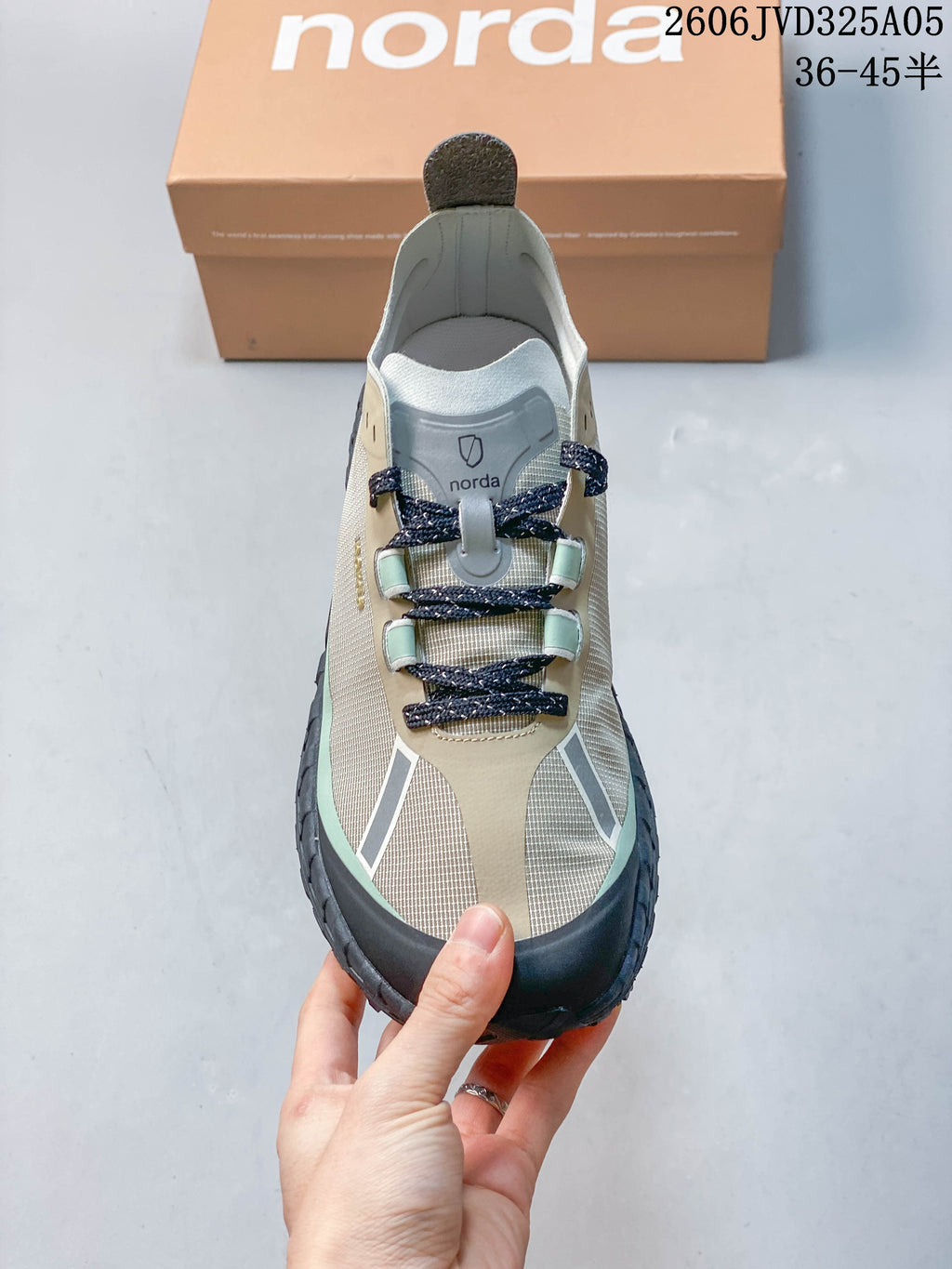 Front view showing the lacing and beige, mint, and dark color details.