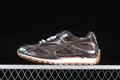 Side view of a brown and silver-tone Bottega Veneta Orbit sneaker with white laces and a tan outsole.