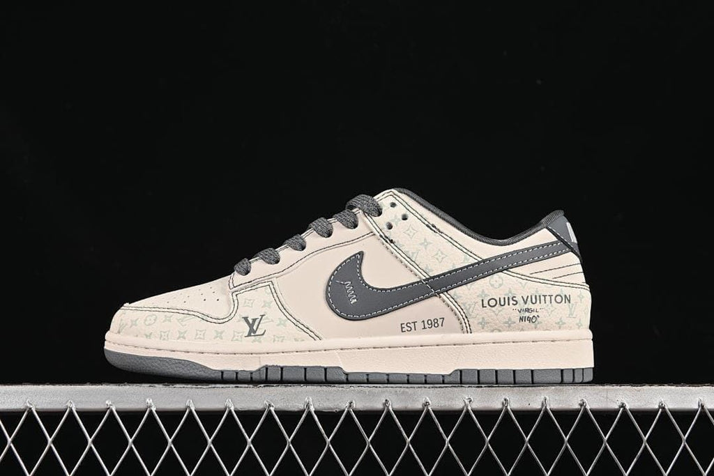 Side profile of a cream and gray low-top Nike SB Dunk-style sneaker with a dark side swoosh.
