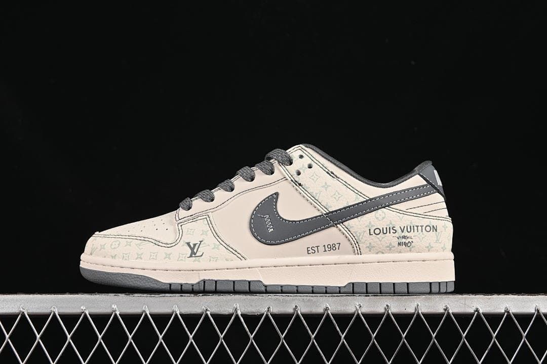 Side profile of a cream and gray low-top Nike SB Dunk-style sneaker with a dark side swoosh.