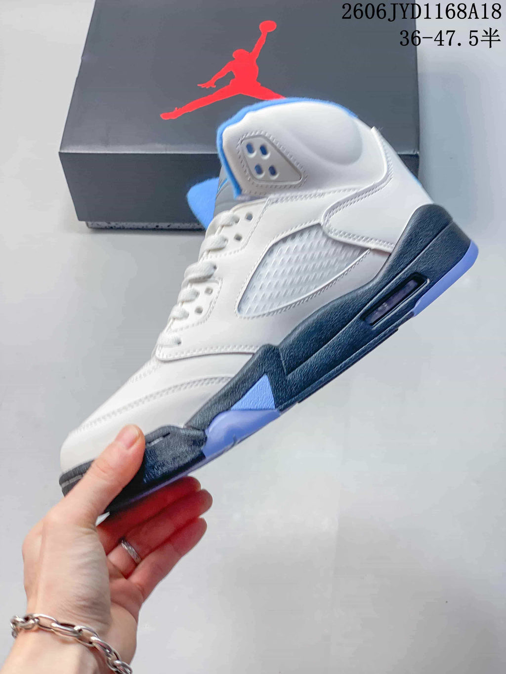 Side view showing mesh panels, a visible midsole air unit, and blue accents