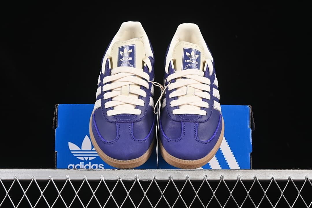 Front view of the sneakers displayed on an adidas box