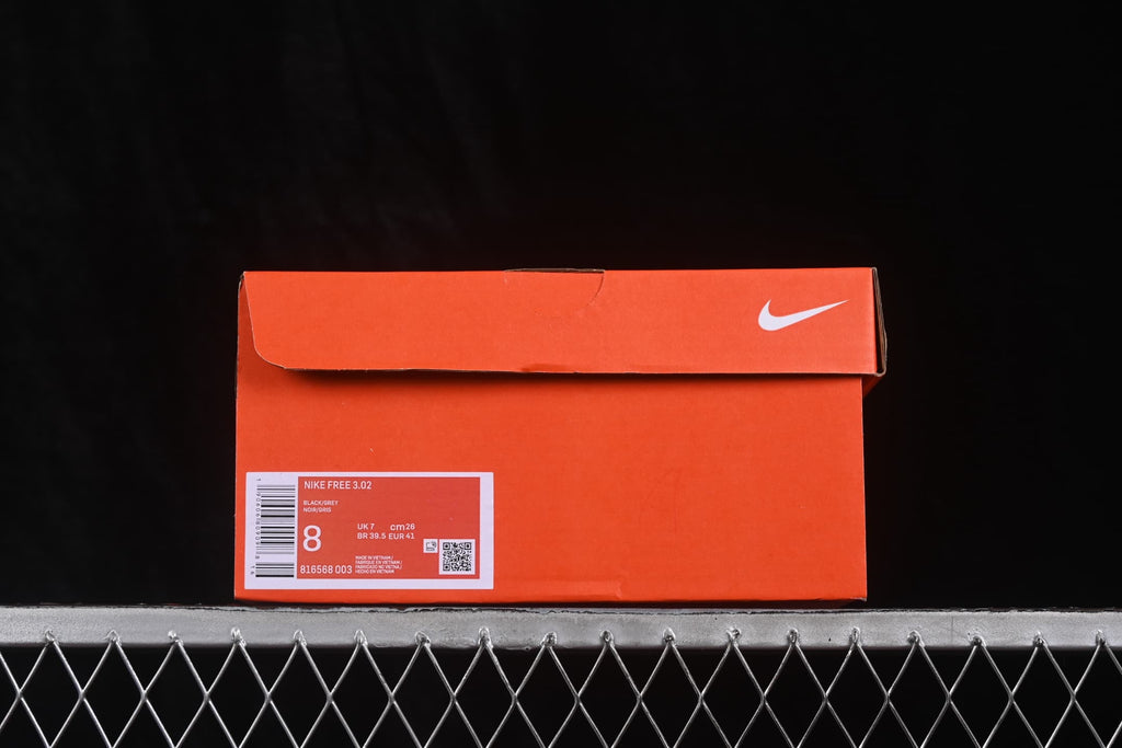 Orange Nike shoe box showing a Nike Free 3.0 label, style code 816568-003, and a photographed size of EU 41.