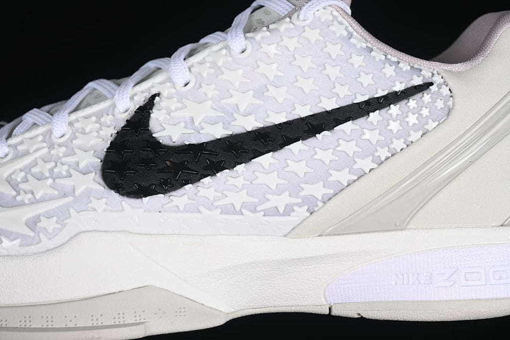 Close-up of raised star pattern and black Swoosh on the upper