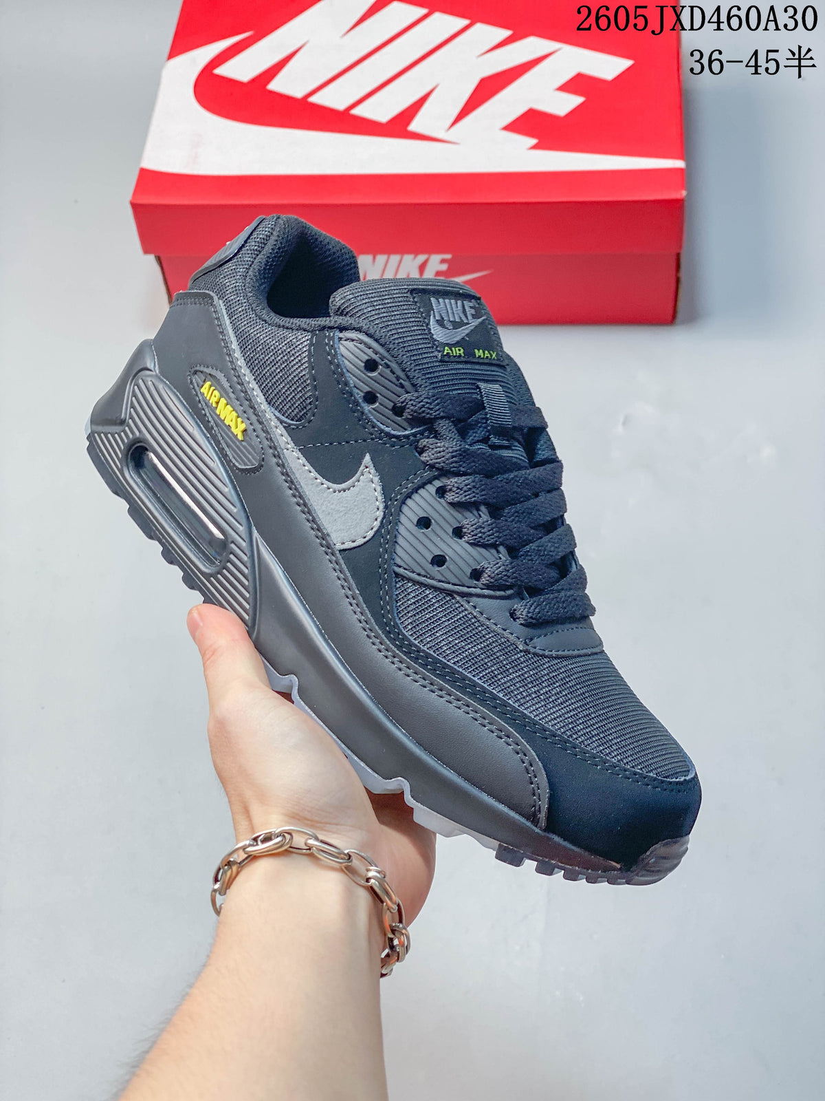 Navy and gray Nike Air Max 90 sneaker with a visible heel Air unit