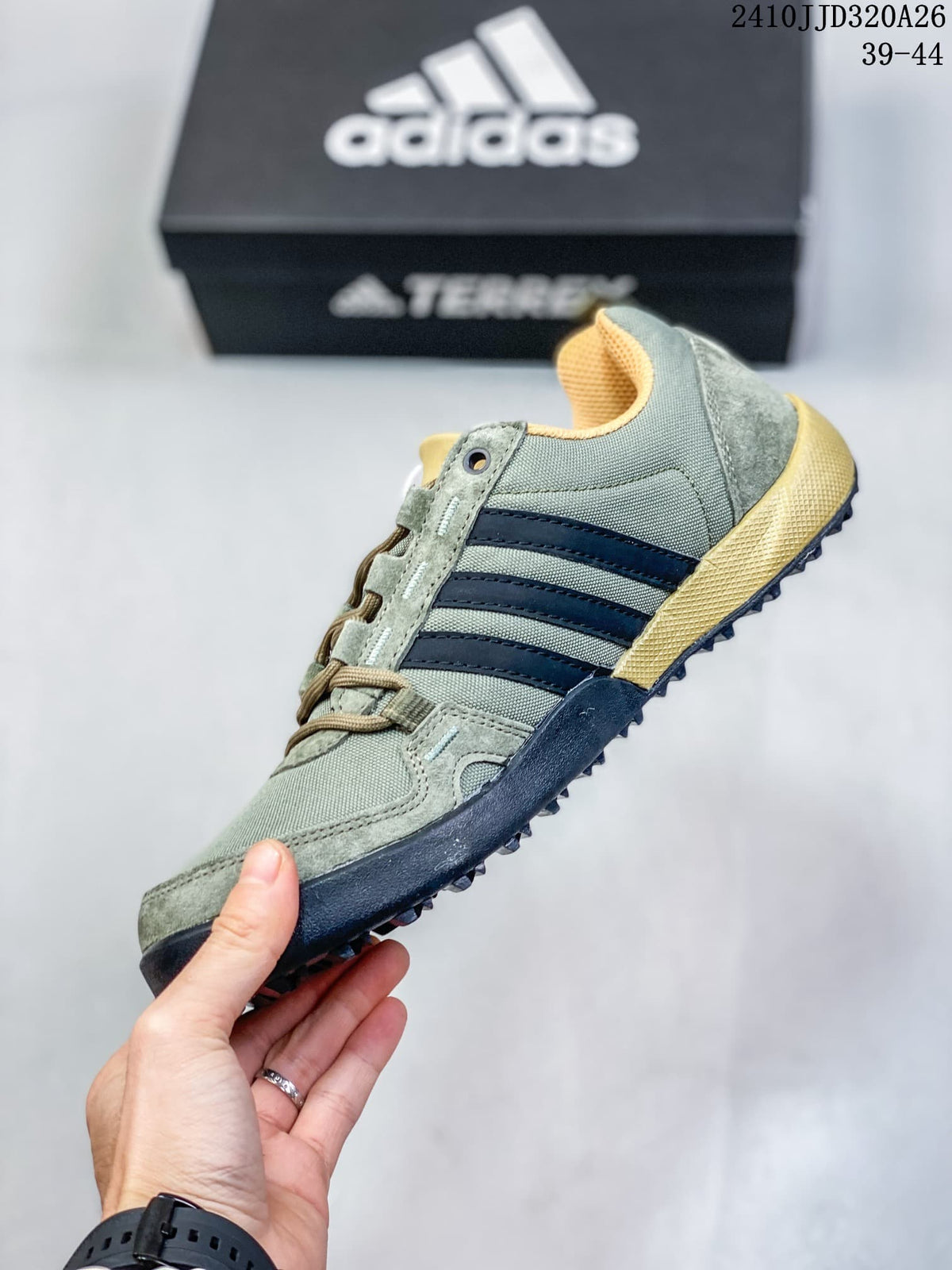Side profile of a green adidas Daroga shoe with dark stripes and a lugged outsole.